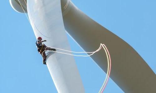 A worker rapelling of a wind turbine